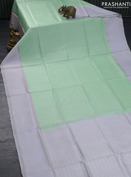 Pure soft silk saree pastel green and pastel grey with allover checked pattern and rettapet silver zari woven border