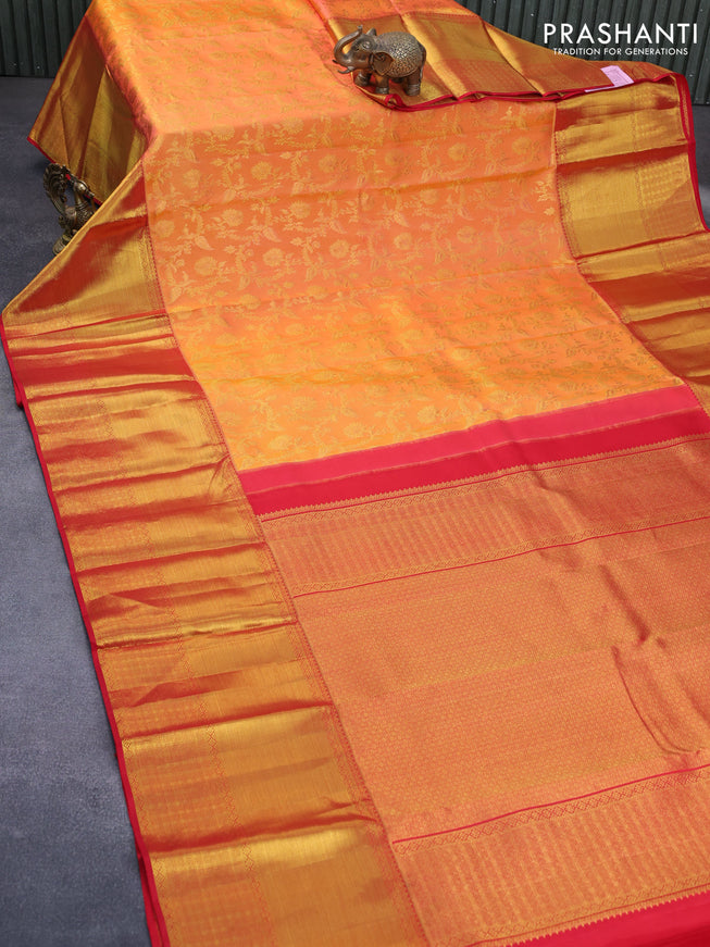 Pure kanchipuram silk saree dual shade of pinkish orange and red with allover zari woven brocade weaves and long zari woven border