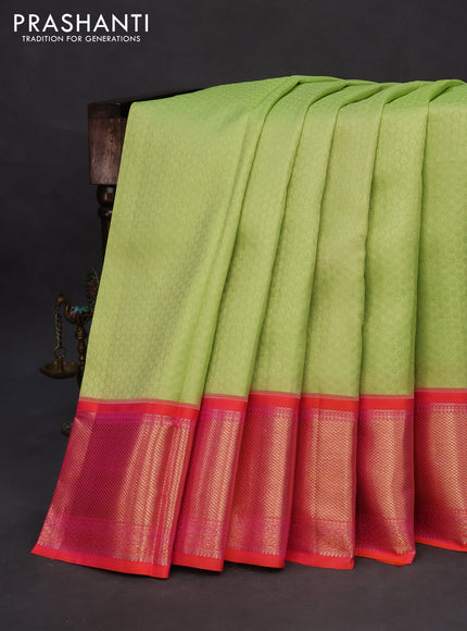 Pure kanchipuram silk saree pista green and dual shade of pinkish orange with allover zari woven brocade weaves and long zari woven peacock design border