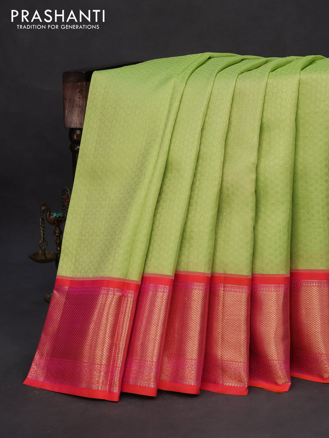 Pure kanchipuram silk saree pista green and dual shade of pinkish orange with allover zari woven brocade weaves and long zari woven peacock design border