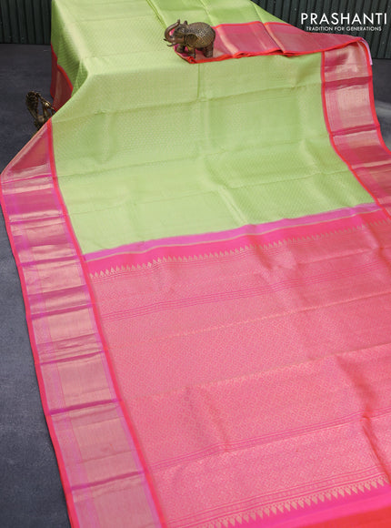 Pure kanchipuram silk saree pista green and dual shade of pinkish orange with allover zari woven brocade weaves and long zari woven peacock design border