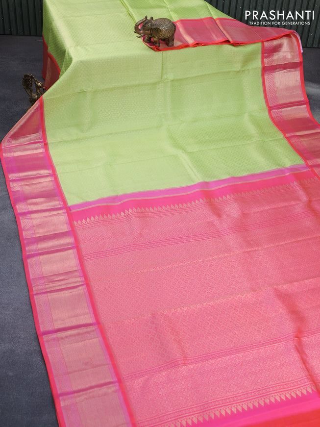 Pure kanchipuram silk saree pista green and dual shade of pinkish orange with allover zari woven brocade weaves and long zari woven peacock design border