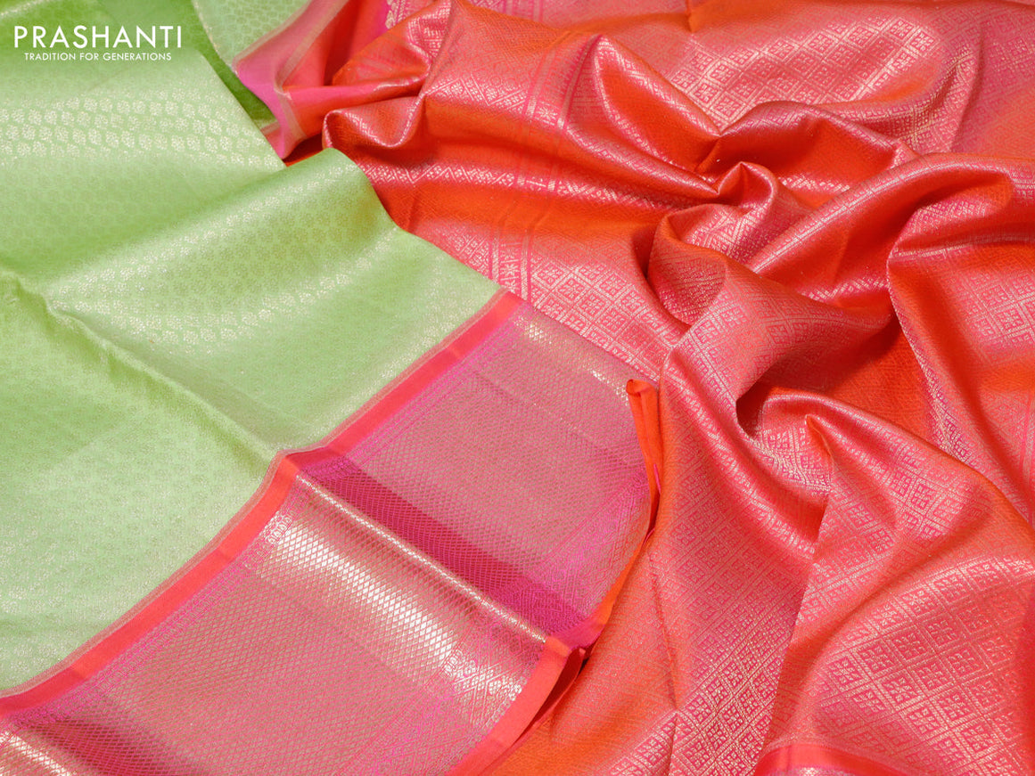 Pure kanchipuram silk saree pista green and dual shade of pinkish orange with allover zari woven brocade weaves and long zari woven peacock design border