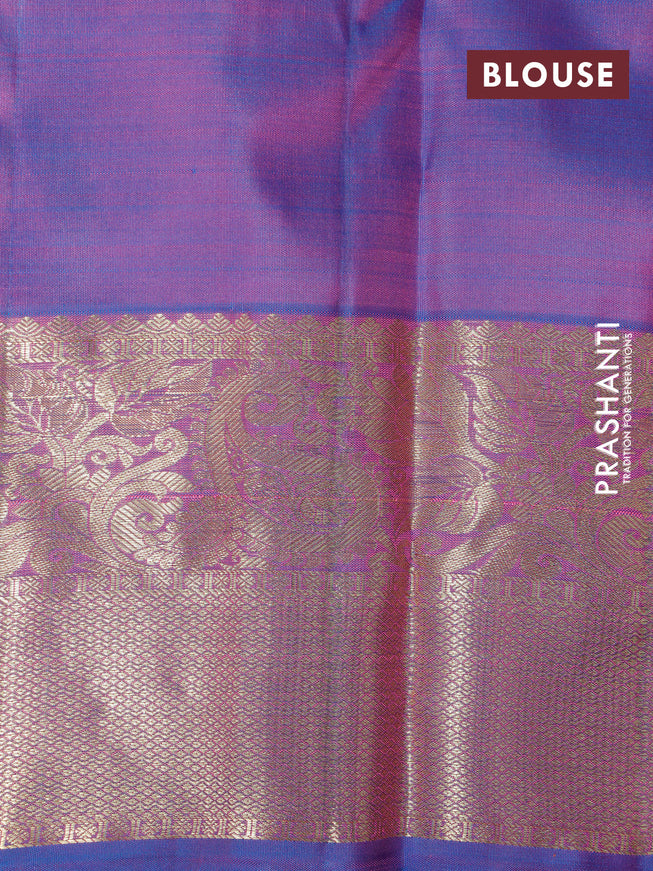 Pure kanchipuram silk saree dual shade of pinkish orange and cs blue with allover self emboss & zari buttas and zari woven border