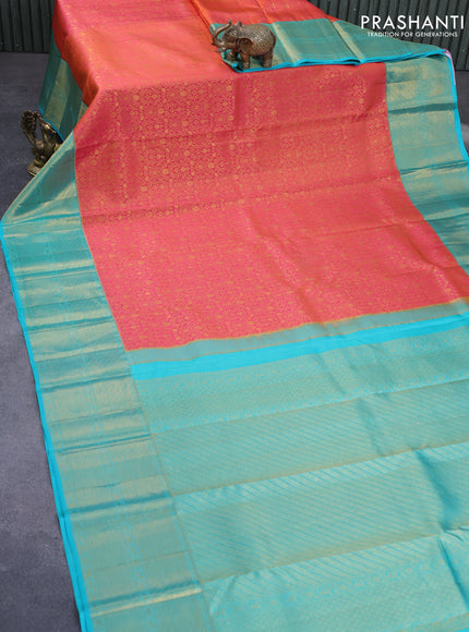 Pure kanchipuram silk saree dual shade of pinkish orange and teal green with allover zari woven brocade weaves and long zari woven border