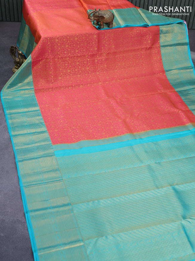 Pure kanchipuram silk saree dual shade of pinkish orange and teal green with allover zari woven brocade weaves and long zari woven border