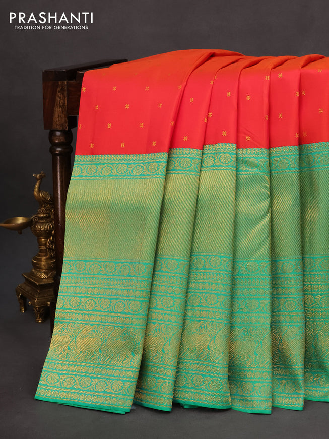 Pure kanchipuram silk saree dual shade of pinkish orange and dual shade of teal bluish green with zari woven buttas and long rich zari woven border