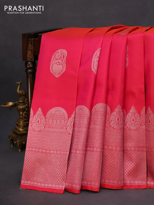 Pure kanchipuram silk saree dual shade of pinkish orange and blue shade with silver zari woven buttas and rich silver zari woven border