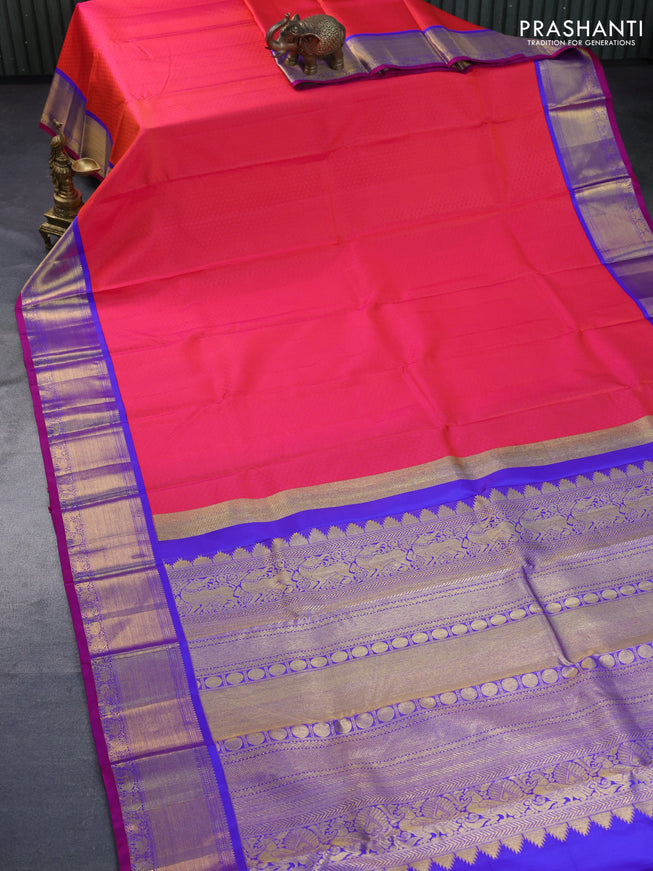 Pure kanchipuram silk saree dual shade of pinkish orange and royal blue with allover self emboss and zari woven border