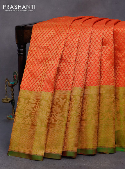 Gadwal silk saree reddish orange and dual shade of green with allover zari woven brocade weaves and long floral zari woven border