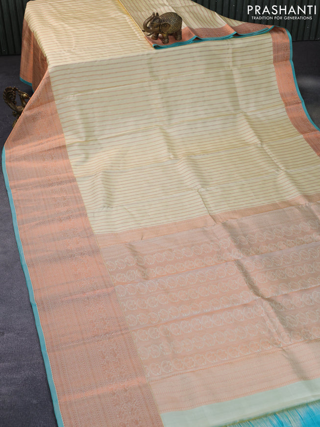 Pure kanchipuram silk saree cream and teal blue with allover copper zari weaves and long copper zari woven border