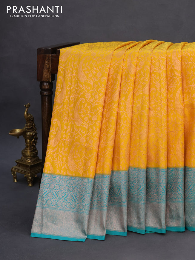 Pure kanchipuram silk saree mustard yellow and teal green with allover copper zari woven brocade weaves and copper zari woven border