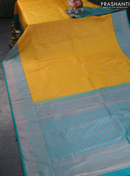 Pure kanchipuram silk saree mustard yellow and teal green with allover copper zari woven brocade weaves and copper zari woven border