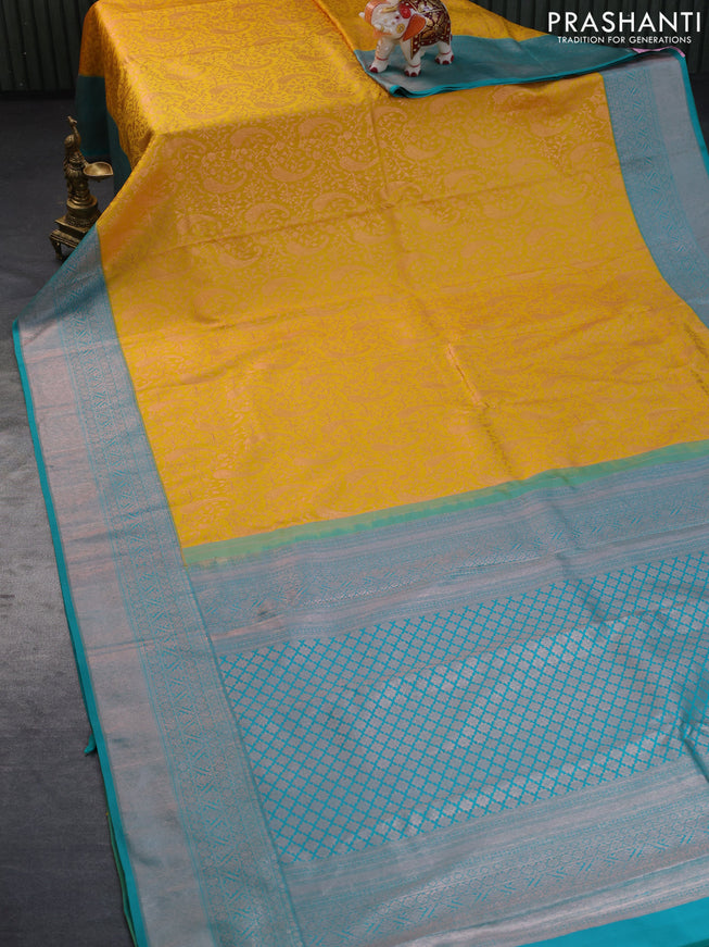 Pure kanchipuram silk saree mustard yellow and teal green with allover copper zari woven brocade weaves and copper zari woven border