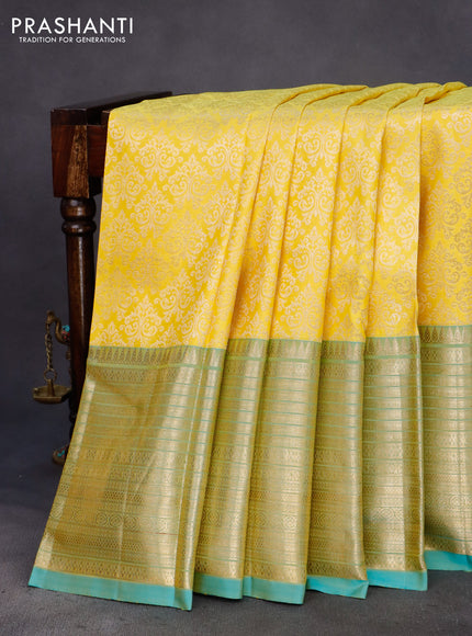 Pure kanchipuram silk saree yellow and dual shade of teal blue with allover zari woven brocade weaves and zari woven border