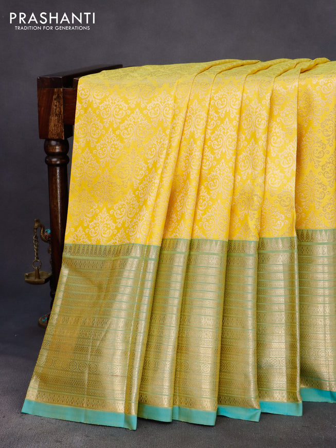 Pure kanchipuram silk saree yellow and dual shade of teal blue with allover zari woven brocade weaves and zari woven border