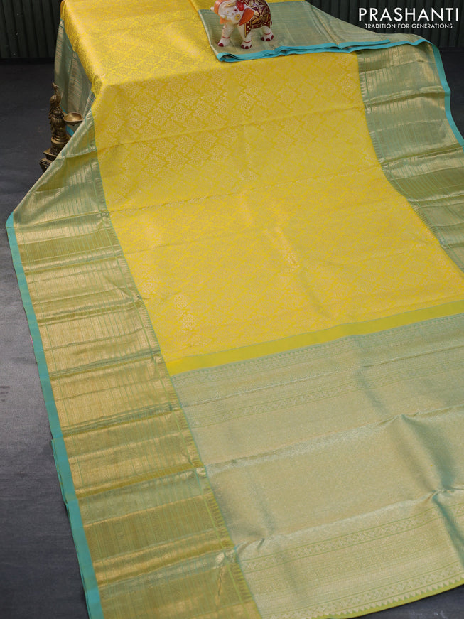 Pure kanchipuram silk saree yellow and dual shade of teal blue with allover zari woven brocade weaves and zari woven border