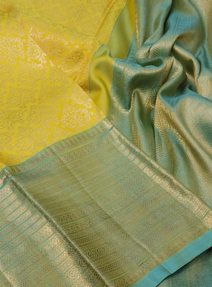 Pure kanchipuram silk saree yellow and dual shade of teal blue with allover zari woven brocade weaves and zari woven border