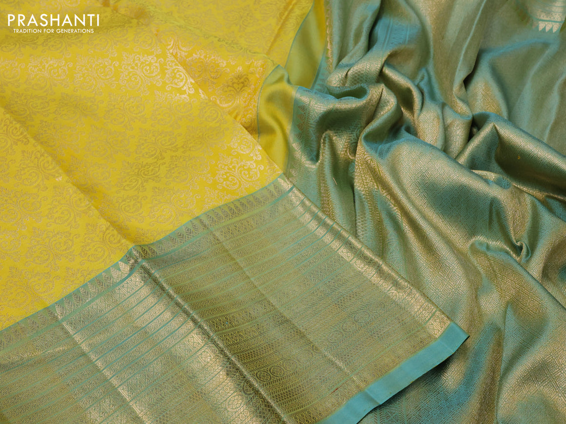 Pure kanchipuram silk saree yellow and dual shade of teal blue with allover zari woven brocade weaves and zari woven border