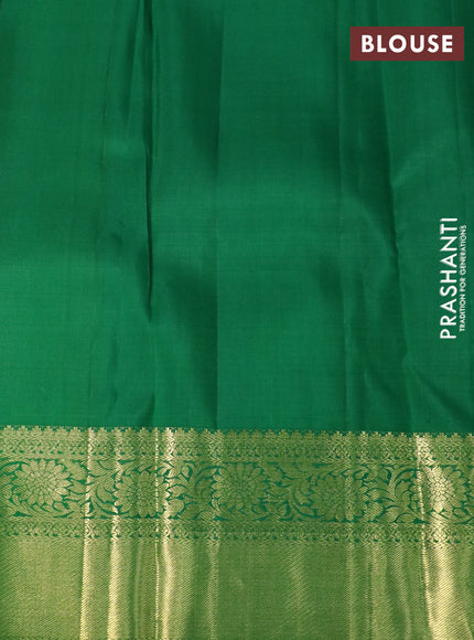 Pure kanchipuram silk saree dual shade of pinkish orange and green with allover zari woven brocade weaves and floral zari woven border