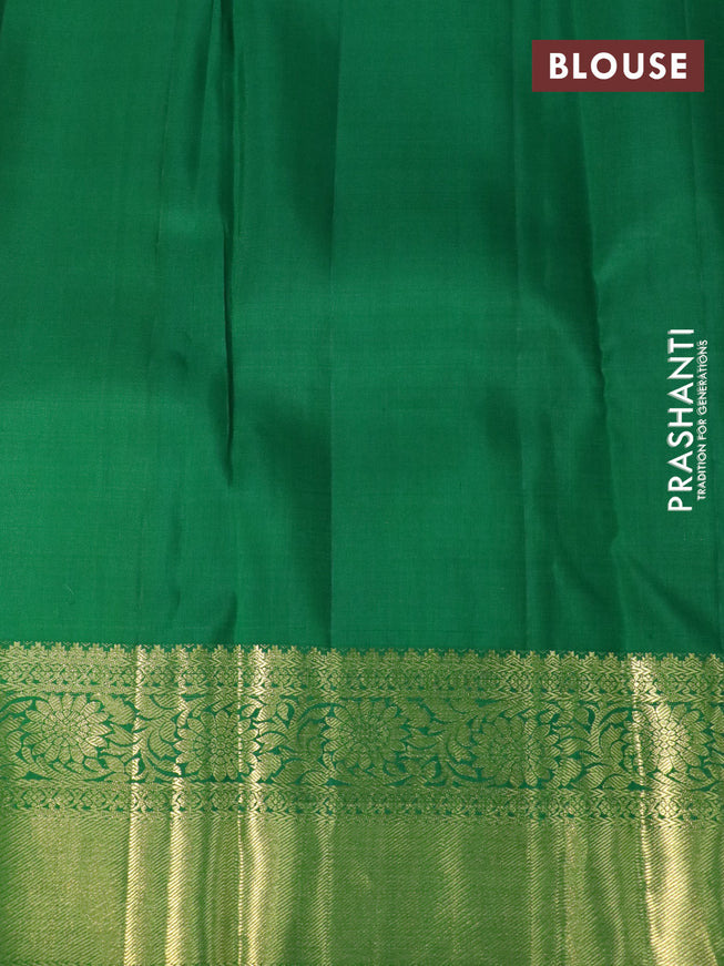 Pure kanchipuram silk saree dual shade of pinkish orange and green with allover zari woven brocade weaves and floral zari woven border