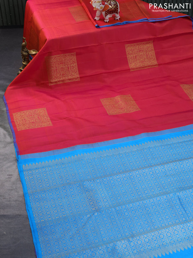 Pure kanchipuram silk saree dual shade of pinkish orange and cs blue with zari woven buttas in borderless style