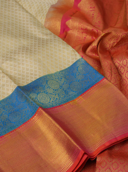 Pure kanchipuram silk saree sandal and dual shade of pinkish orange with allover zari woven butta weaves and long zari woven border