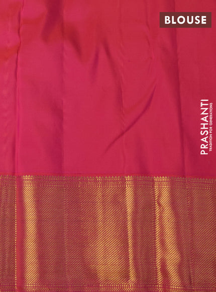 Pure kanchipuram silk saree sandal and dual shade of pinkish orange with allover zari woven butta weaves and long zari woven border