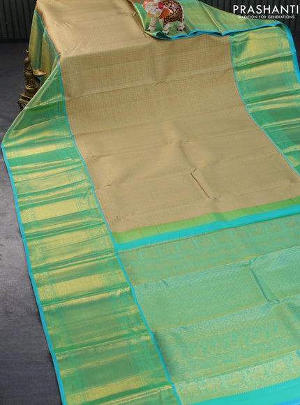 Pure kanchipuram silk saree sandal and teal blue with allover zari woven brocade weaves and long zari woven border