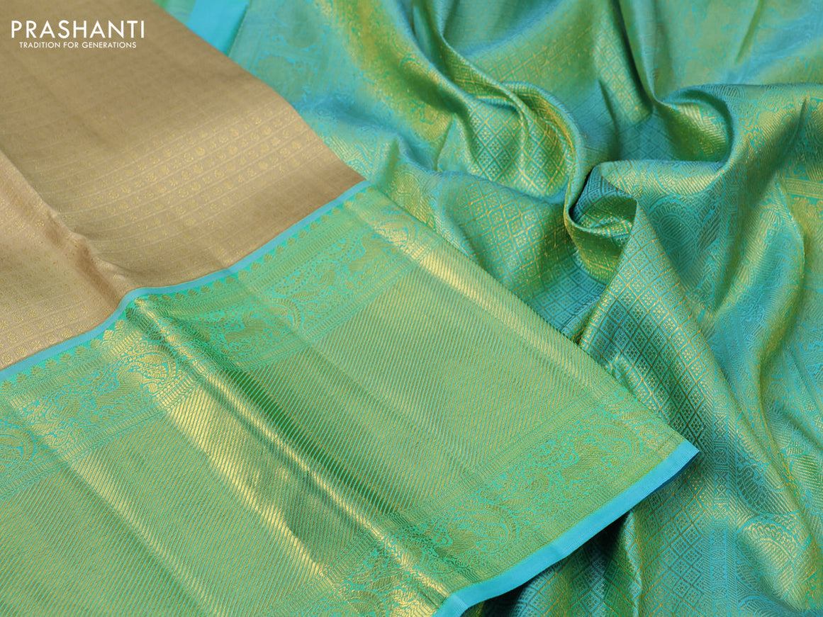 Pure kanchipuram silk saree sandal and teal blue with allover zari woven brocade weaves and long zari woven border