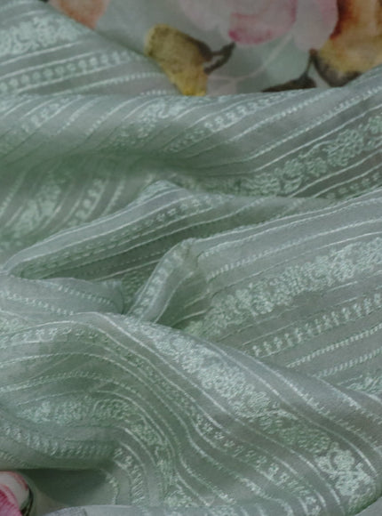 Pure organza partly silk saree pastel green with embroidery work buttas and floral printed embroidery work border