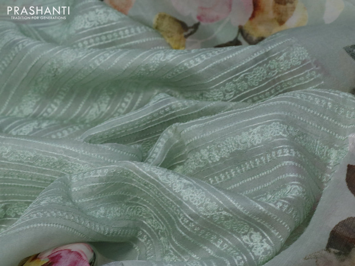 Pure organza partly silk saree pastel green with embroidery work buttas and floral printed embroidery work border