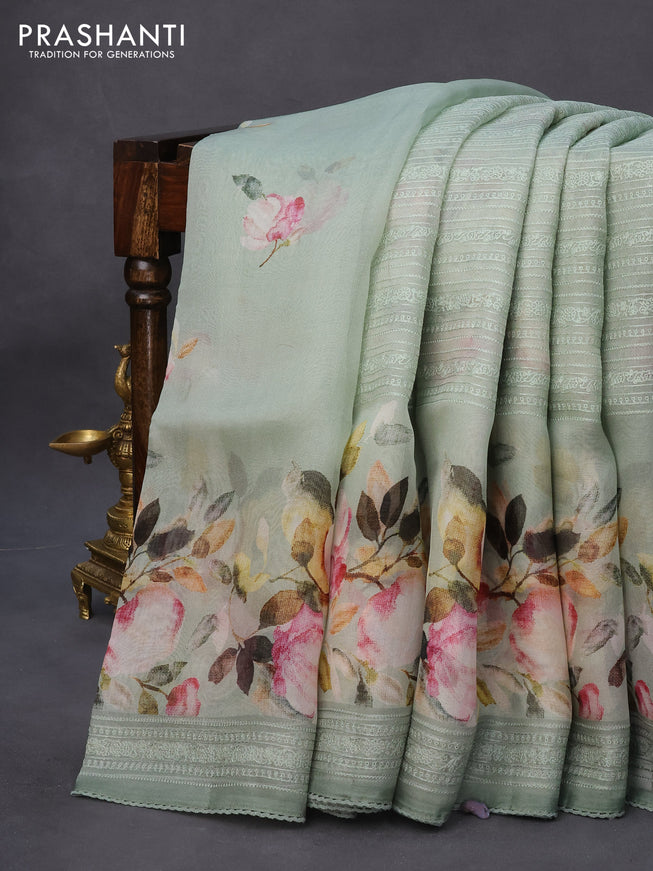 Pure organza partly silk saree pastel blue shade with embroidery work buttas and floral printed embroidery work border