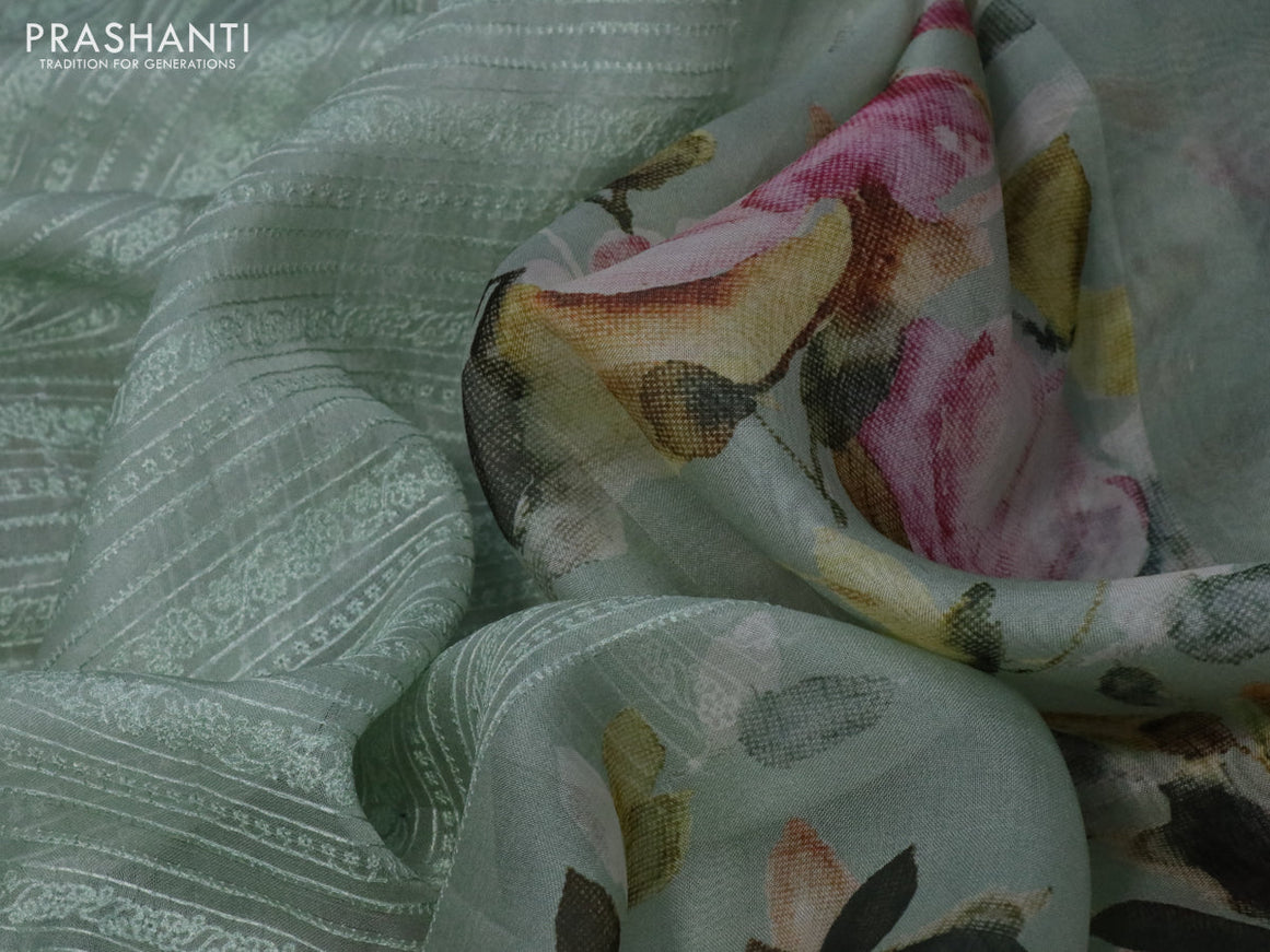 Pure organza partly silk saree pastel blue shade with embroidery work buttas and floral printed embroidery work border