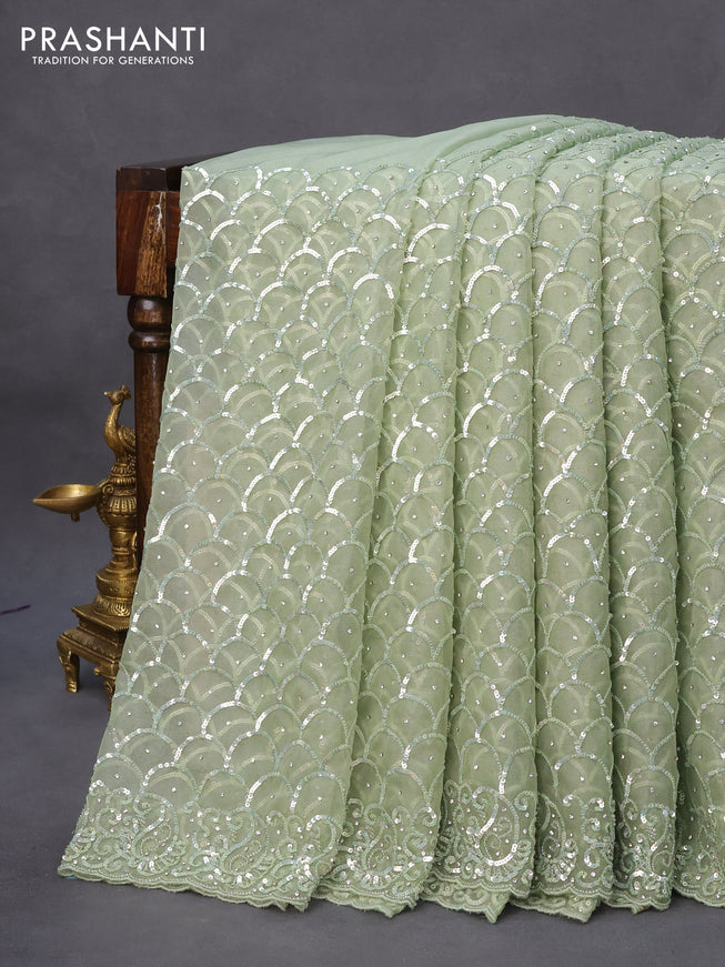 Organza silk saree pastel green with allover sequin work and sequin beaded work border