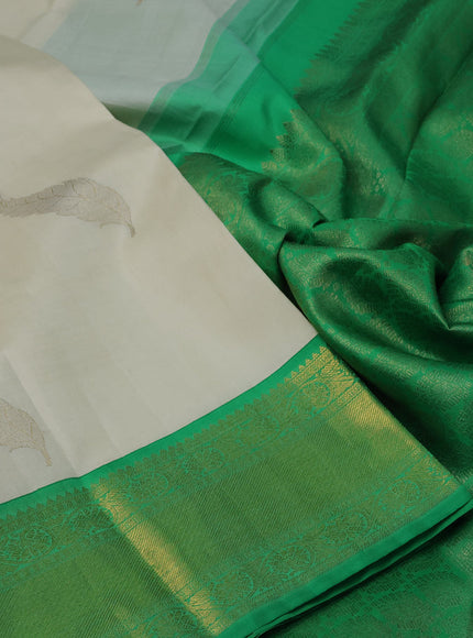 Pure kanchipuram silk saree off white and green with zari woven leaf buttas and zari woven border