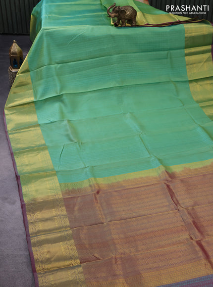 Pure kanchipuram silk saree teal green shade and dual shade of pink with allover self emboss and zari woven border