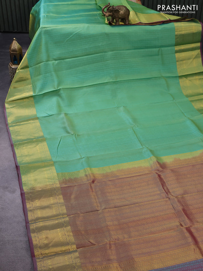 Pure kanchipuram silk saree teal green shade and dual shade of pink with allover self emboss and zari woven border