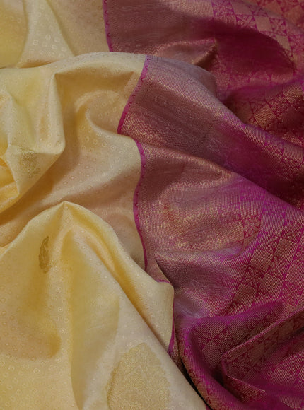 Pure kanchipuram silk saree pale yellow and pink with allover self emboss & zari buttas and zari woven border