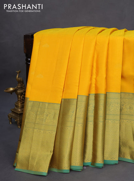 Pure kanchipuram silk saree mango yellow and dual shade of teal green with allover self emboss & zari buttas and long zari woven border