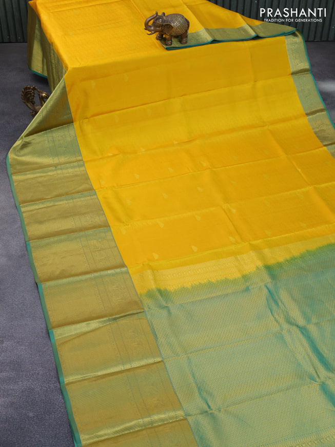 Pure kanchipuram silk saree mango yellow and dual shade of teal green with allover self emboss & zari buttas and long zari woven border