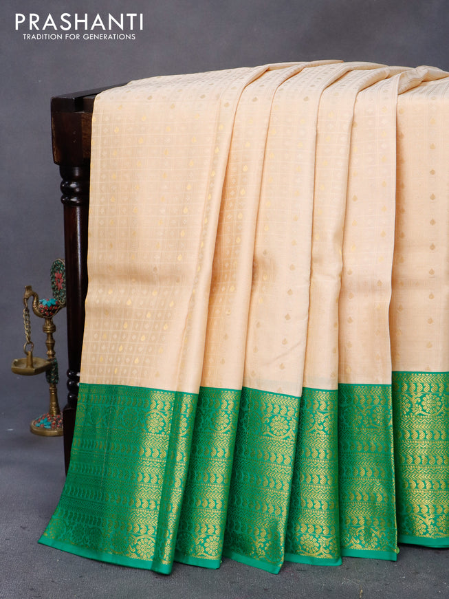 Pure kanchipuram silk saree cream and green with allover self emboss & zari buttas and long zari woven border