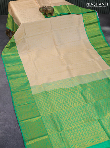 Pure kanchipuram silk saree cream and green with allover self emboss & zari buttas and long zari woven border