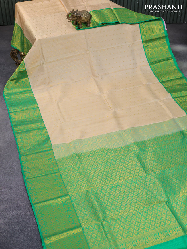 Pure kanchipuram silk saree cream and green with allover self emboss & zari buttas and long zari woven border