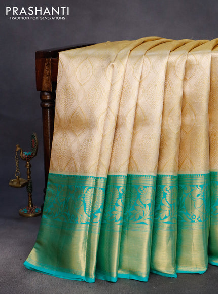 Pure kanchipuram tissue silk saree gold and teal blue with allover zari woven brocade weaves and long rich zari woven border