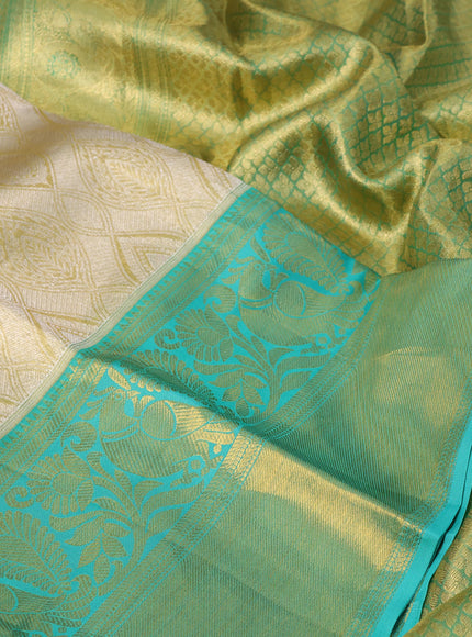 Pure kanchipuram tissue silk saree gold and teal blue with allover zari woven brocade weaves and long rich zari woven border