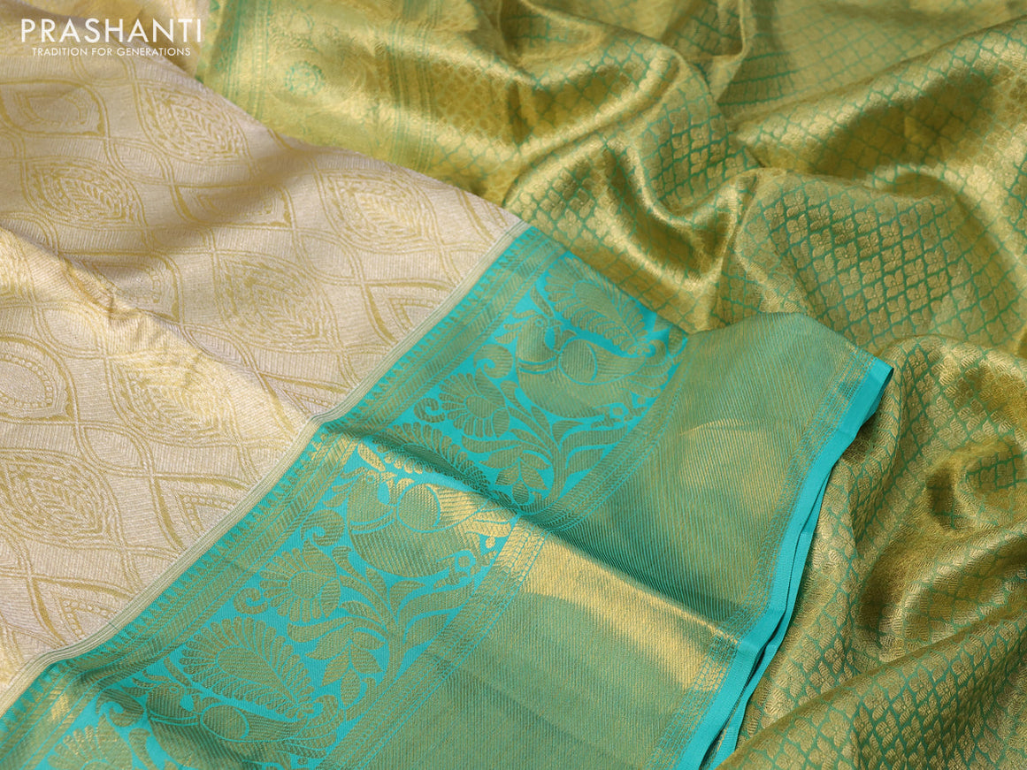 Pure kanchipuram tissue silk saree gold and teal blue with allover zari woven brocade weaves and long rich zari woven border