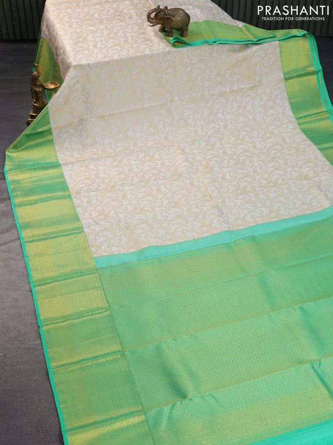 Pure kanchipuram silk saree off white and green with allover zari woven brocade weaves and long zari woven border