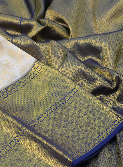 Pure kanchipuram silk saree off white and navy blue with allover zari woven brocade weaves and long rich zari woven border