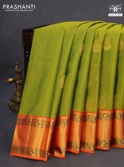 Pure kanchipuram silk saree light green and orange with paisley zari woven buttas and zari woven korvai border